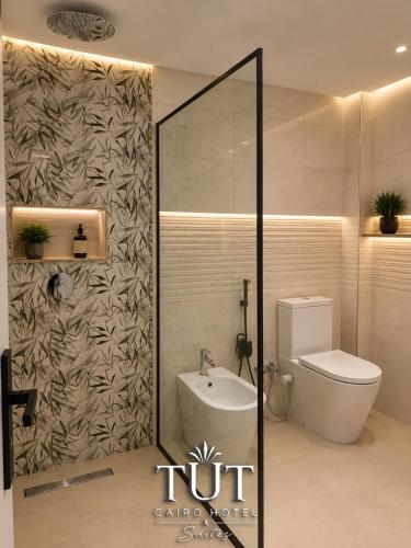 a bathroom with a toilet and a sink at TUT Cairo Hotel & Suites in Cairo