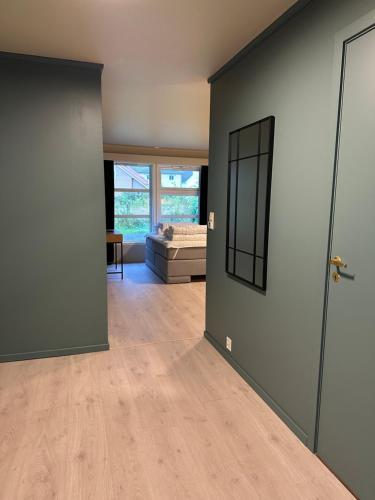 an empty living room with a door and a couch at Villa Fresvik in Fresvik