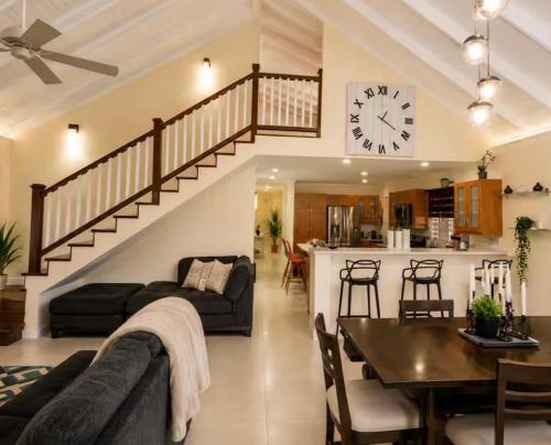 a living room with a couch and a clock on the wall at Apartment in St Ann in Priory