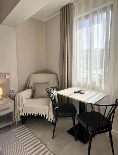 a small room with a table and chairs and a window at Rain Suite in Istanbul