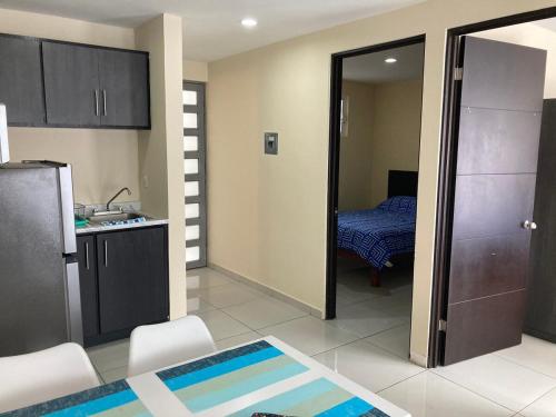 a kitchen with a door open to a room at Beautiful, comfortable and functional apartment 4 in Guadalupe