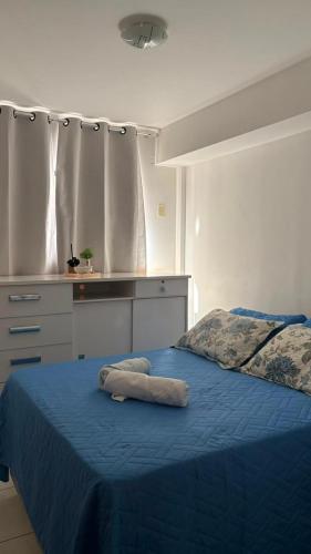 a bedroom with a bed with a blue bedspread at Prive in Paulista