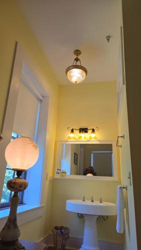 a bathroom with a sink and a mirror at Catherine's Palace in Vicksburg
