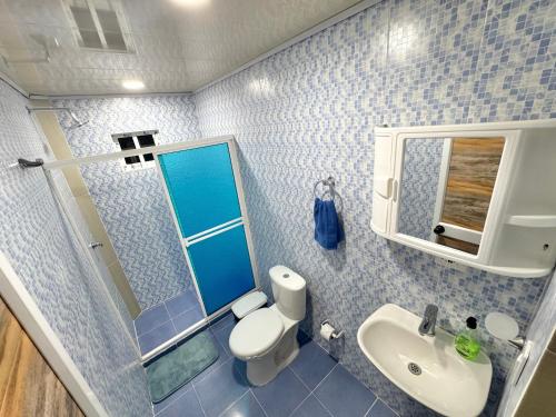 a bathroom with a toilet and a sink and a mirror at posada nativa NIYKA in Casabaja