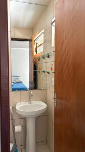 a bathroom with a sink and a mirror at Prive in Paulista