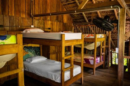 a room with three bunk beds in a cabin at The Humpback Turtle in El Valle