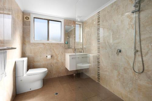 a bathroom with a toilet and a shower at Ocean Retreat in Nambucca Heads