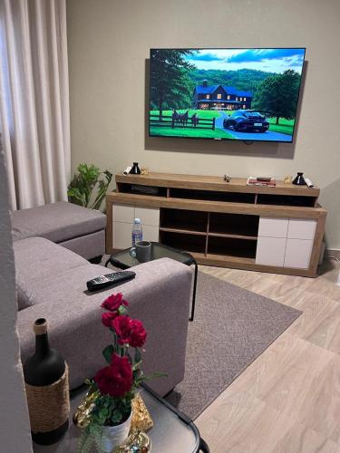 a living room with a couch and a flat screen tv at Lynch Apartments 2 - Mimosa Chilanga in Lusaka