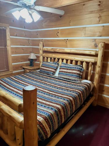 a bed in a room with a wooden wall at Sugar Bear in Sevierville