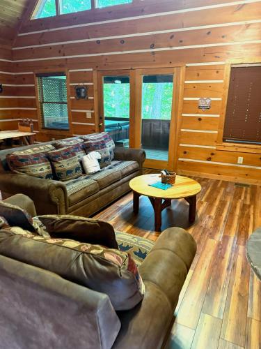 a living room with couches and a table at Sugar Bear in Sevierville