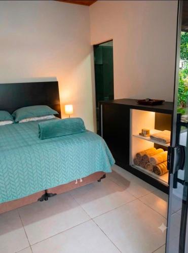 a bedroom with a bed and a dresser with a mirror at A Oca Praiana Suites in Ilha Comprida