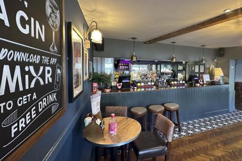 a restaurant with a table and chairs and a bar at Lobster Sheringham in Sheringham