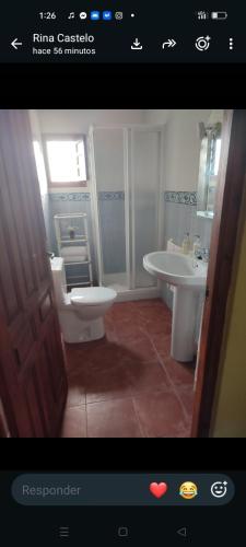 a bathroom with a toilet and a sink at Sunshines on the sea in Almuñécar