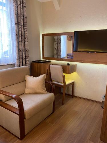 a living room with a couch and a large mirror at Kaan Pansiyon in Bartın