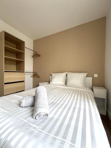 a bedroom with a large white bed with two pillows at LOCAPONDI 5 - Les Reflets du Canal in Pontivy