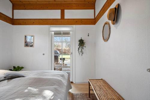 a bedroom with a bed and a wooden ceiling at 1087-Stege-Berberisvej-7 in Stege