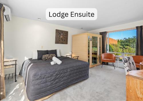 a bedroom with a large bed and a table and chairs at Vibrant Living Retreat in Hanmer Springs