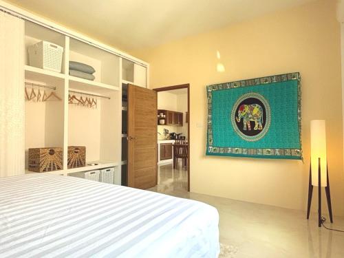 a bedroom with a bed and a painting on the wall at Duplex Villa 1 in Trat