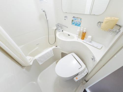 a bathroom with a toilet and a sink at Super Hotel Morioka in Morioka