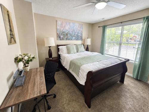 a bedroom with a bed and a desk and a window at Spacious 3BR Retreat Perfect for Groups Near Downtown in Raleigh