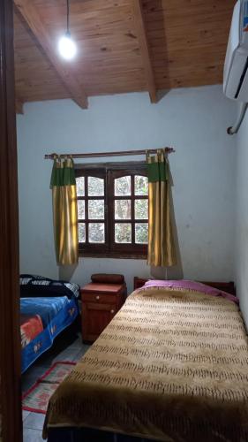 a bedroom with two beds and a window at Vivienda Wagner in Dos de Mayo