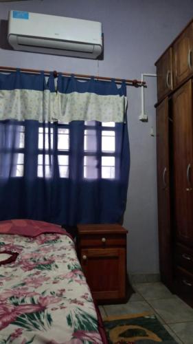 a bedroom with a bed and a dresser and a window at Vivienda Wagner in Dos de Mayo