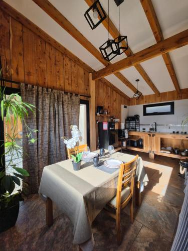 a dining room with a table and a kitchen at Cabañas Dos Maitenes in Villa Traful