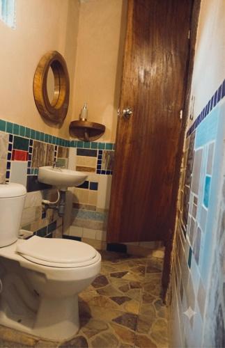 a bathroom with a toilet and a sink at A-típico in Santa Marta
