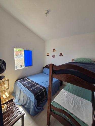 a bedroom with two bunk beds and a window at Chalet da Bela Vista in Itamaracá