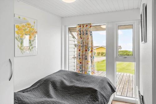 a bedroom with a bed and an open window at G237-Lemvig-Syrenvej-37 in Lemvig