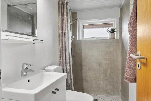 a bathroom with a sink and a toilet and a shower at G237-Lemvig-Syrenvej-37 in Lemvig