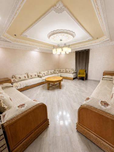 a large room with two beds and a table at Nzaha house in Douar Ahmed Ben Brahim