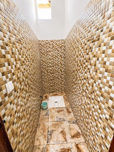 a bathroom with a shower with a toilet in it at Nzaha house in Douar Ahmed Ben Brahim