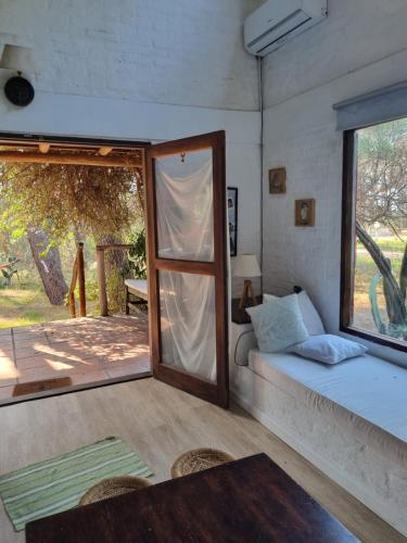 a room with a bed and a sliding glass door at Casa bosque y mar in Ocean Park