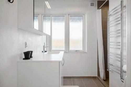 a white kitchen with a sink and a window at 729-Thyboron-Vesterhavsgade-112 in Thyborøn