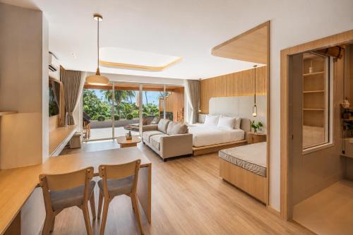 a hotel room with a bed and a living room at Ban's Diving Resort in Ko Tao