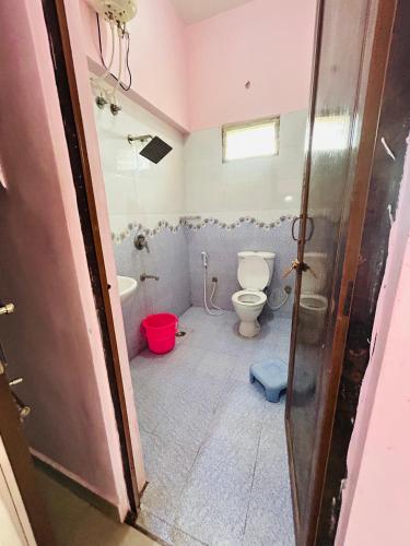 a bathroom with a toilet and a sink at Breezevalley Residency in Yelagiri