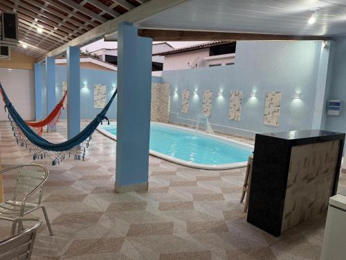 a large pool with a hammock in a building at Aquarela do Sertão in Piranhas