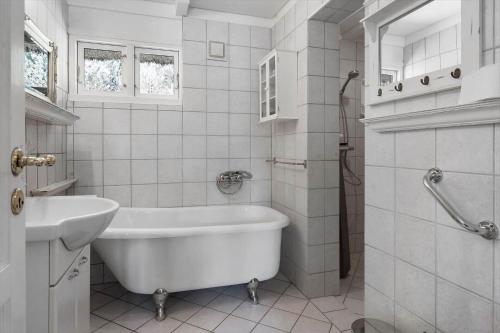 a white bathroom with a tub and a sink at 0140-Romo-Kap-Farvel-7 in Høm