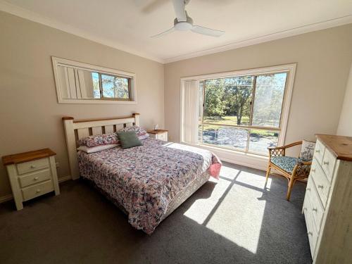 a bedroom with a bed and a window at Parkview Lodge - Bring your own linen. in South West Rocks