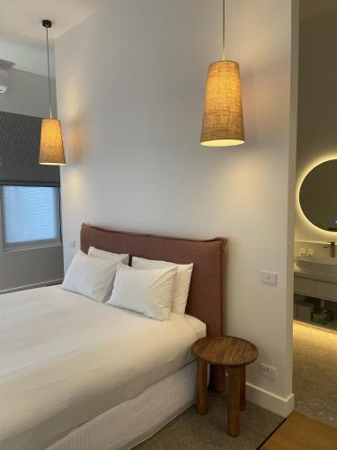a bedroom with a bed with two pillows and a table at The Porcupine Place in Sale