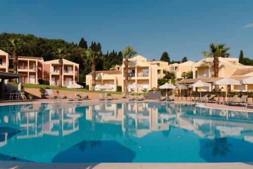 a large swimming pool in front of some condos at Olympion Village in Kavos