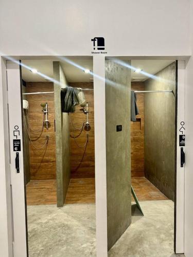 a bathroom with two shower stalls in a room at 9 mins to BTS Queen Bed Private Room - Share Bath in Amphoe Phra Khanong
