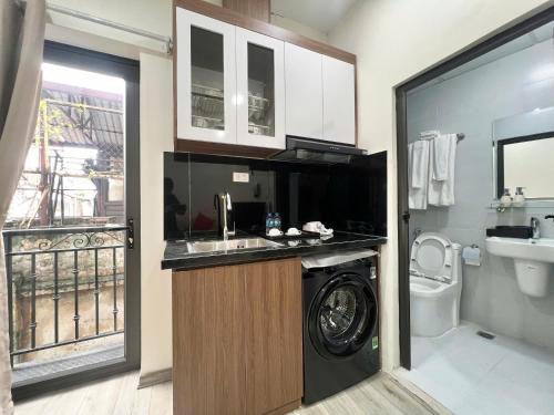 a bathroom with a washer and a sink and a washing machine at Aurora Homestay in Hanoi