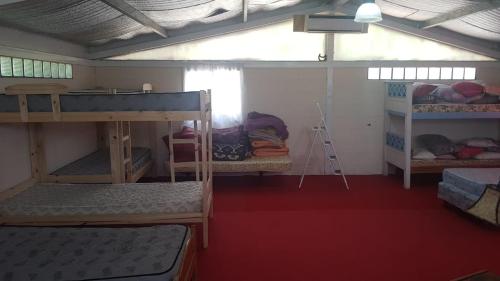 a room with several bunk beds and a ladder at El Campito in Abasto