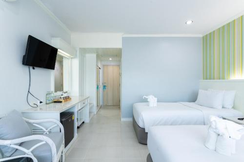 a hotel room with two beds and a tv at Krabi Royal Hotel in Krabi