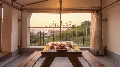 a table in a room with a large window at Samcheok Sea Road Pension in Samcheok