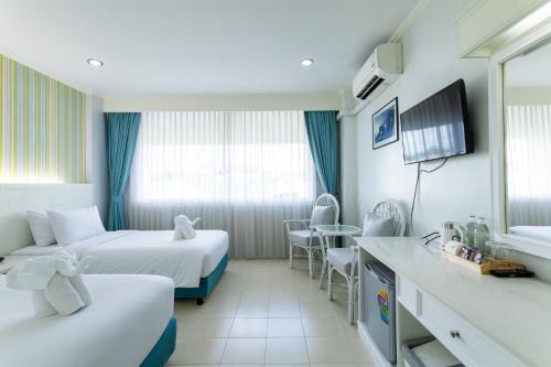 a hotel room with two beds and a table at Krabi Royal Hotel in Krabi