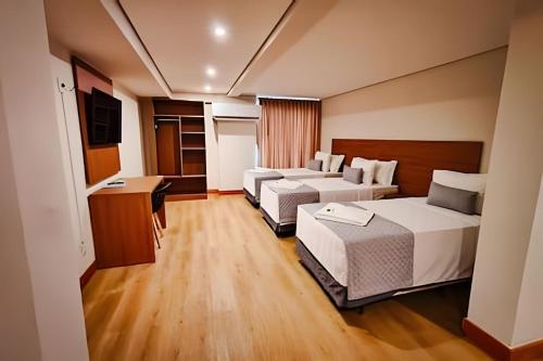 a hotel room with two beds and a television at Hotel Amazon Seasons VN in Belém