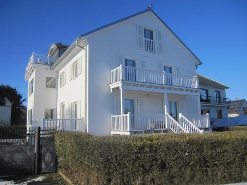 a large white house with a fence in front of it at Haus Grünewald Unsleben in Unsleben